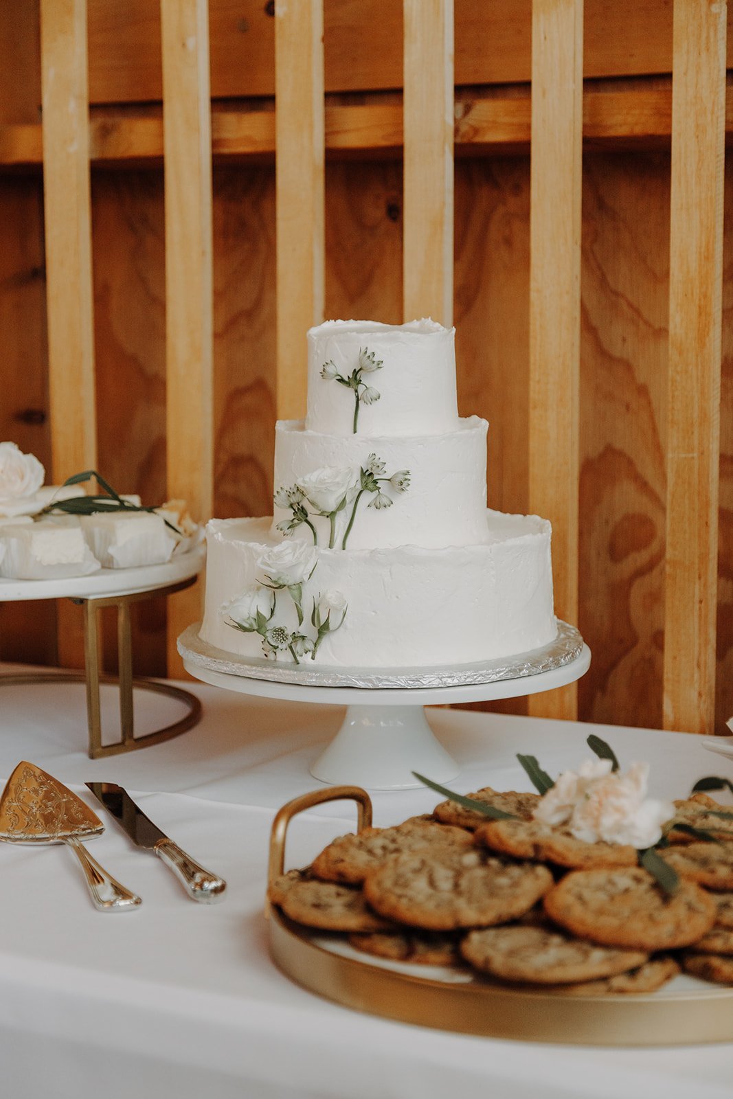 White three tier wedding cake with green leaves