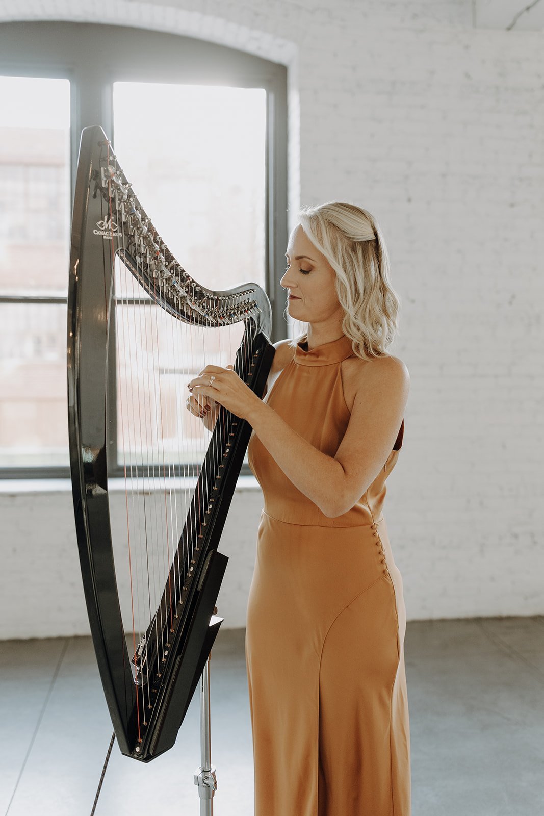 Harpist playing during wedding ceremony at non-traditional wedding