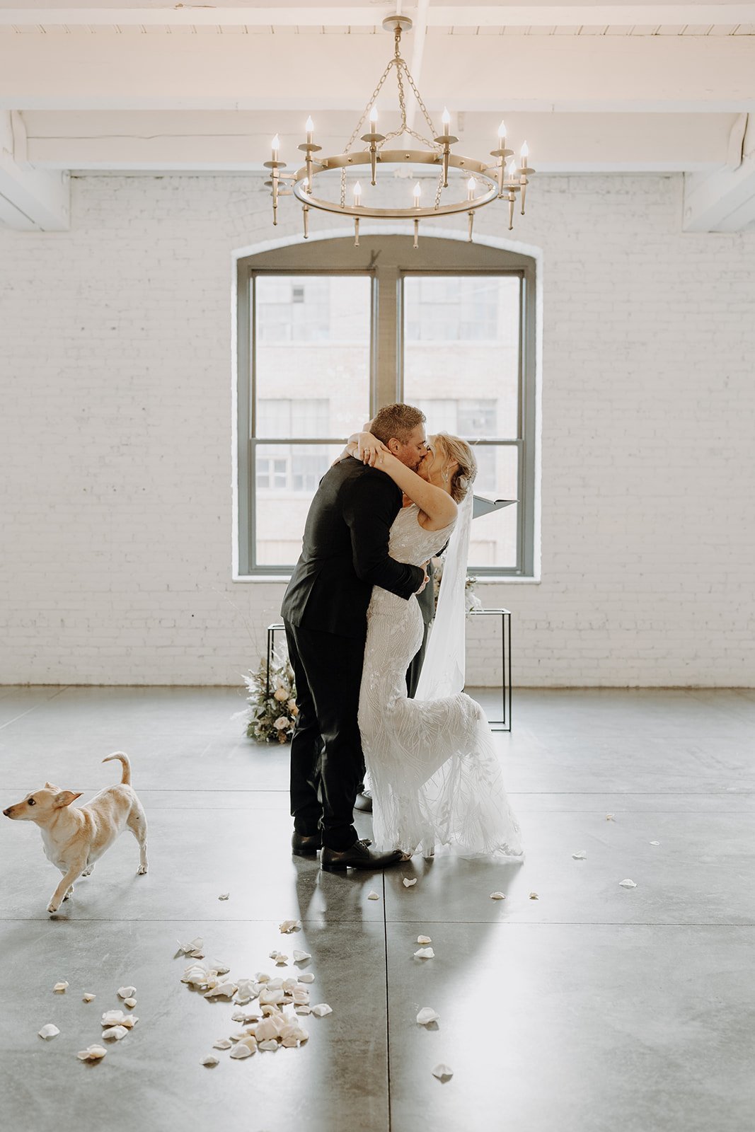 Bride and groom kiss during wedding ceremony at Company 251 wedding venue in Illinois