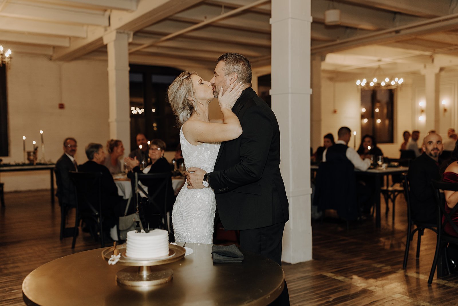 Bride and groom kissing at wedding reception at non-traditional wedding