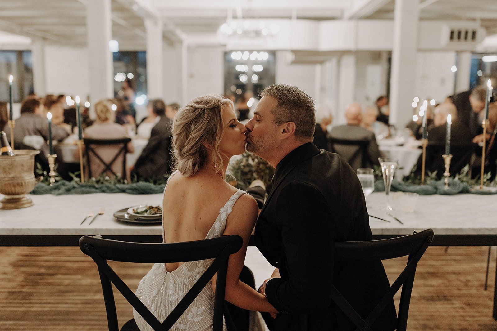 Bride and groom kissing at non-traditional wedding reception at Company 251 wedding venue