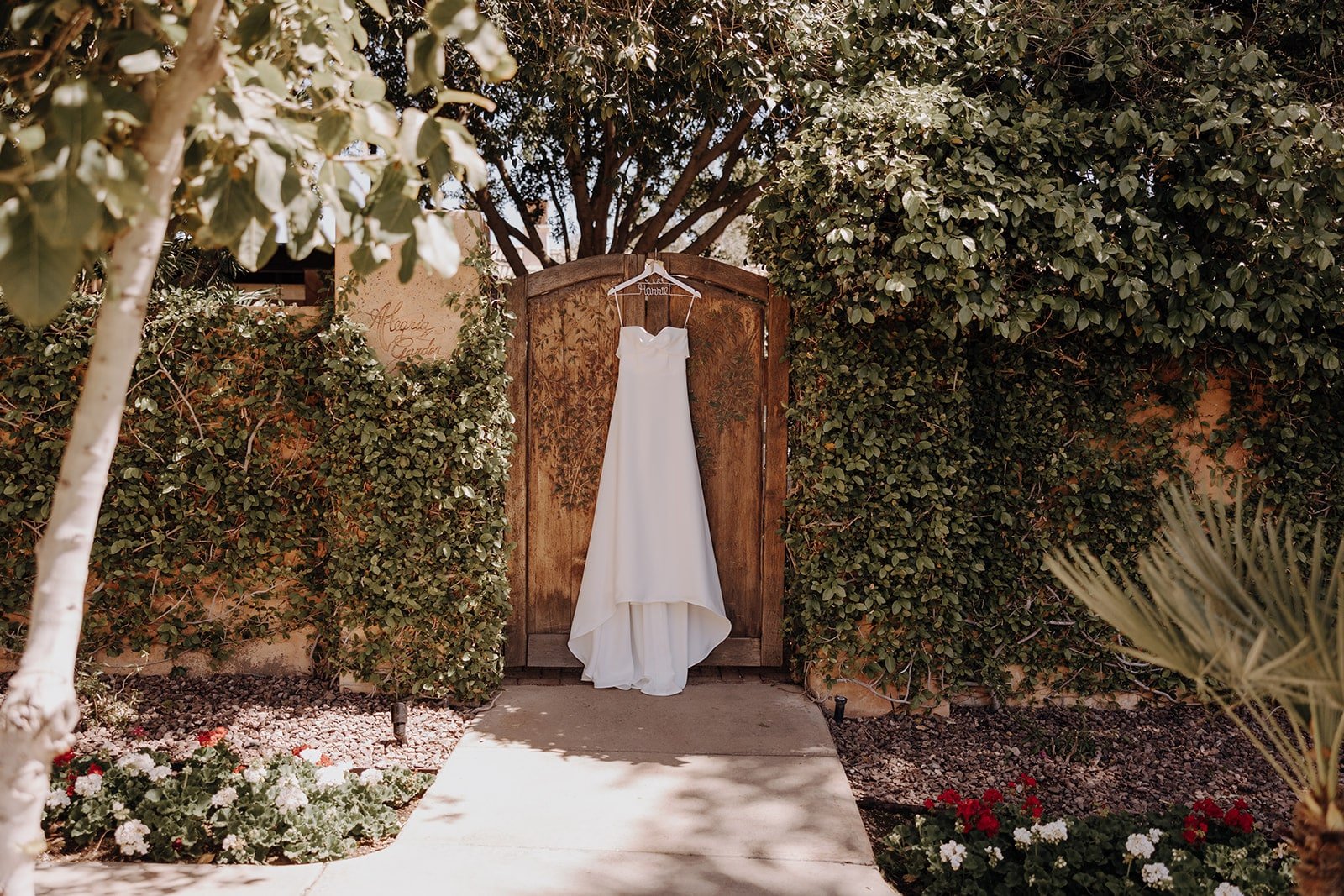 White wedding dress hanging on the door at Royal Palms Resort in Arizona