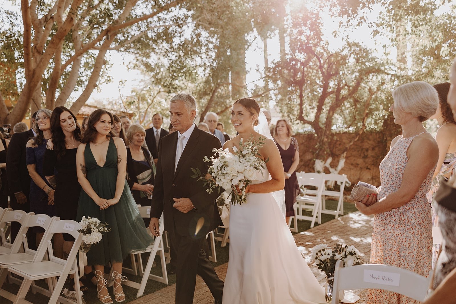 Bride walks down the aisle on her father's arm at luxury resort wedding in Arizona