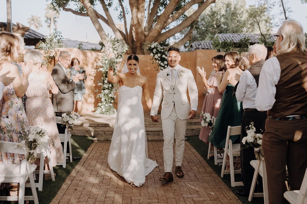 Bride and groom exit luxury resort wedding ceremony at Royal Palm Resort &amp; Spa