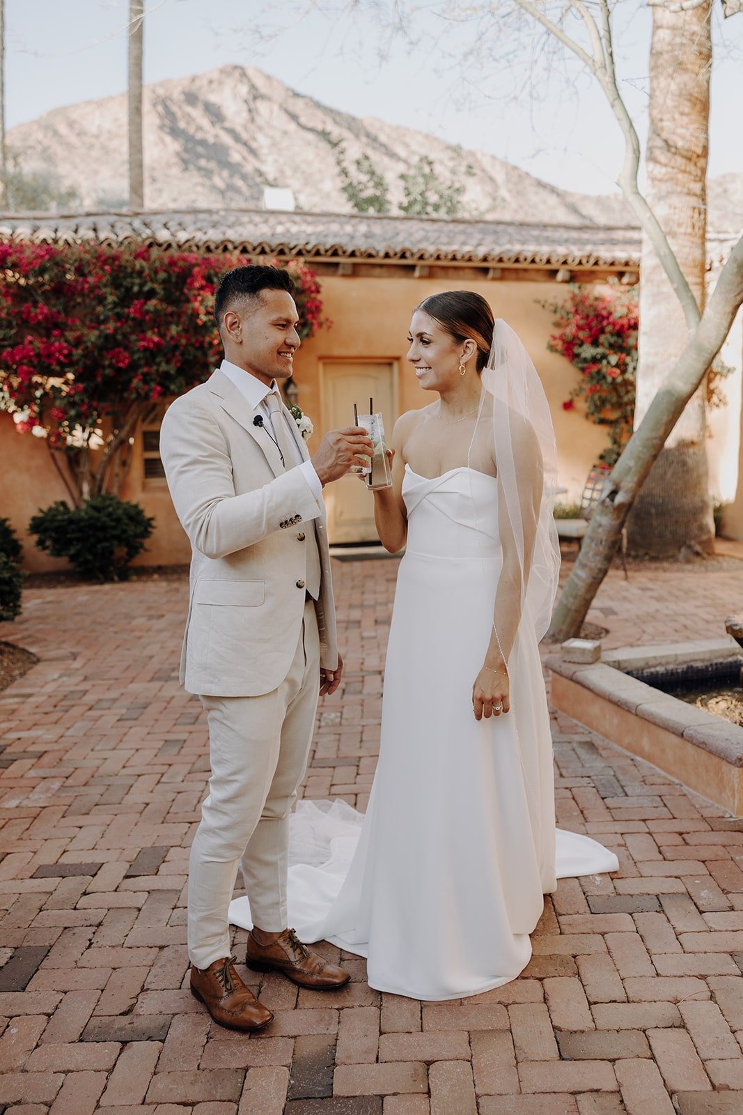 Bride and groom toast after luxury resort wedding ceremony at Royal Palm Resort &amp; Spa