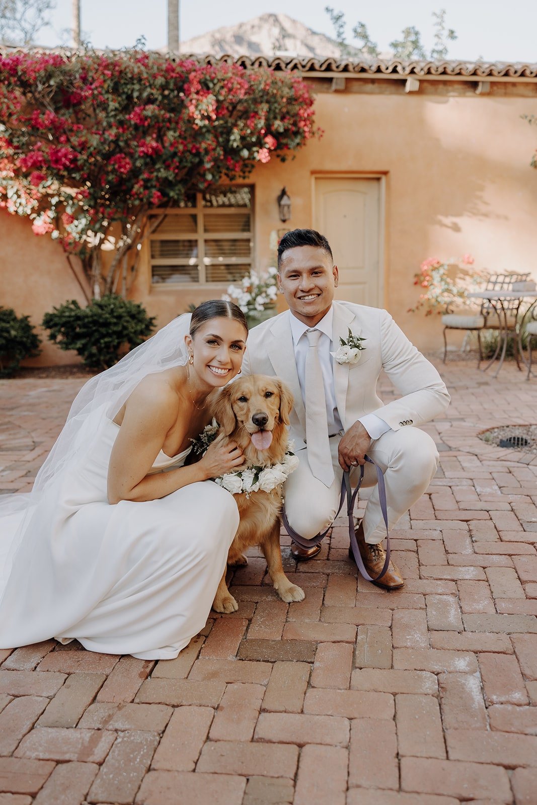 Bride and groom photo with their golden retriever dog