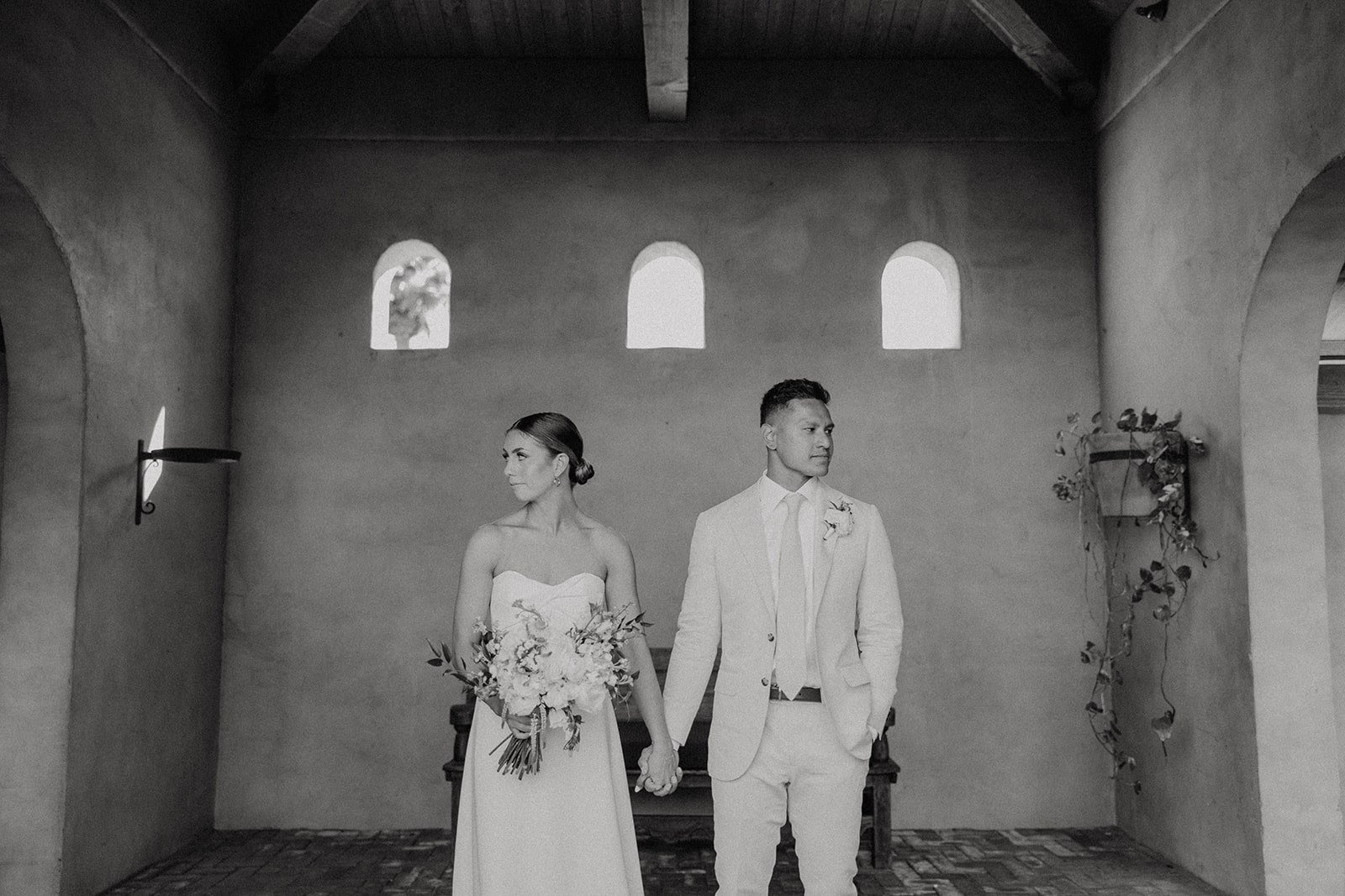 Bride and groom hold hands during wedding photos at luxury resort wedding venue in Arizona