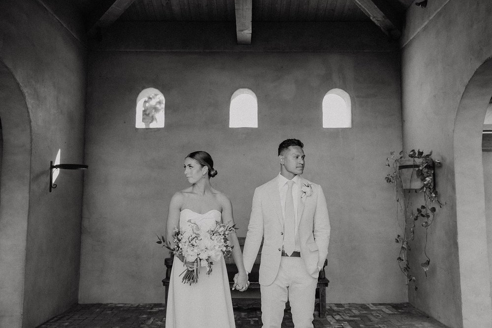 Bride and groom hold hands during wedding photos at luxury resort wedding venue in Arizona