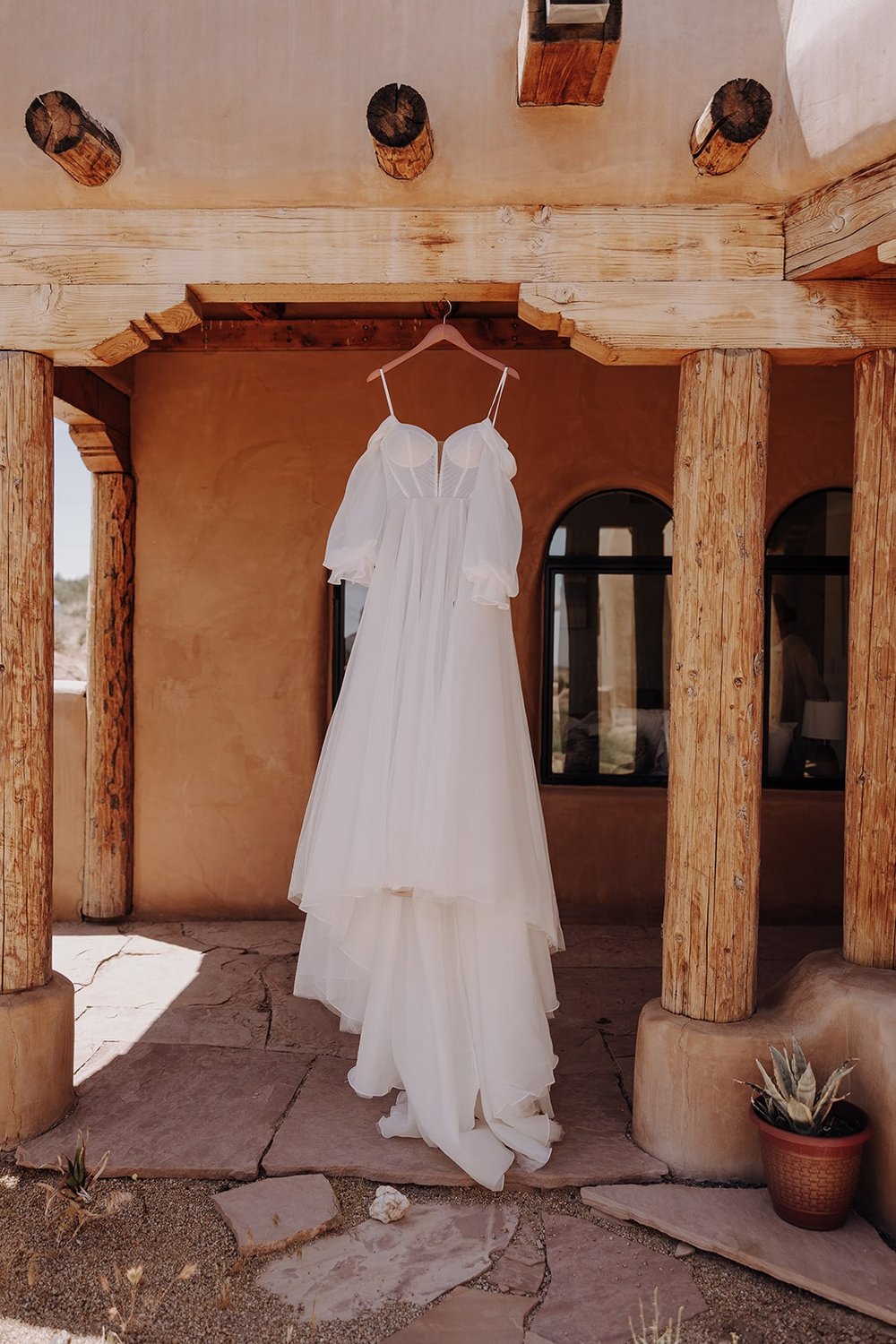 white wedding dress hanging from the ceiling of a wedding venue in Joshua Tree