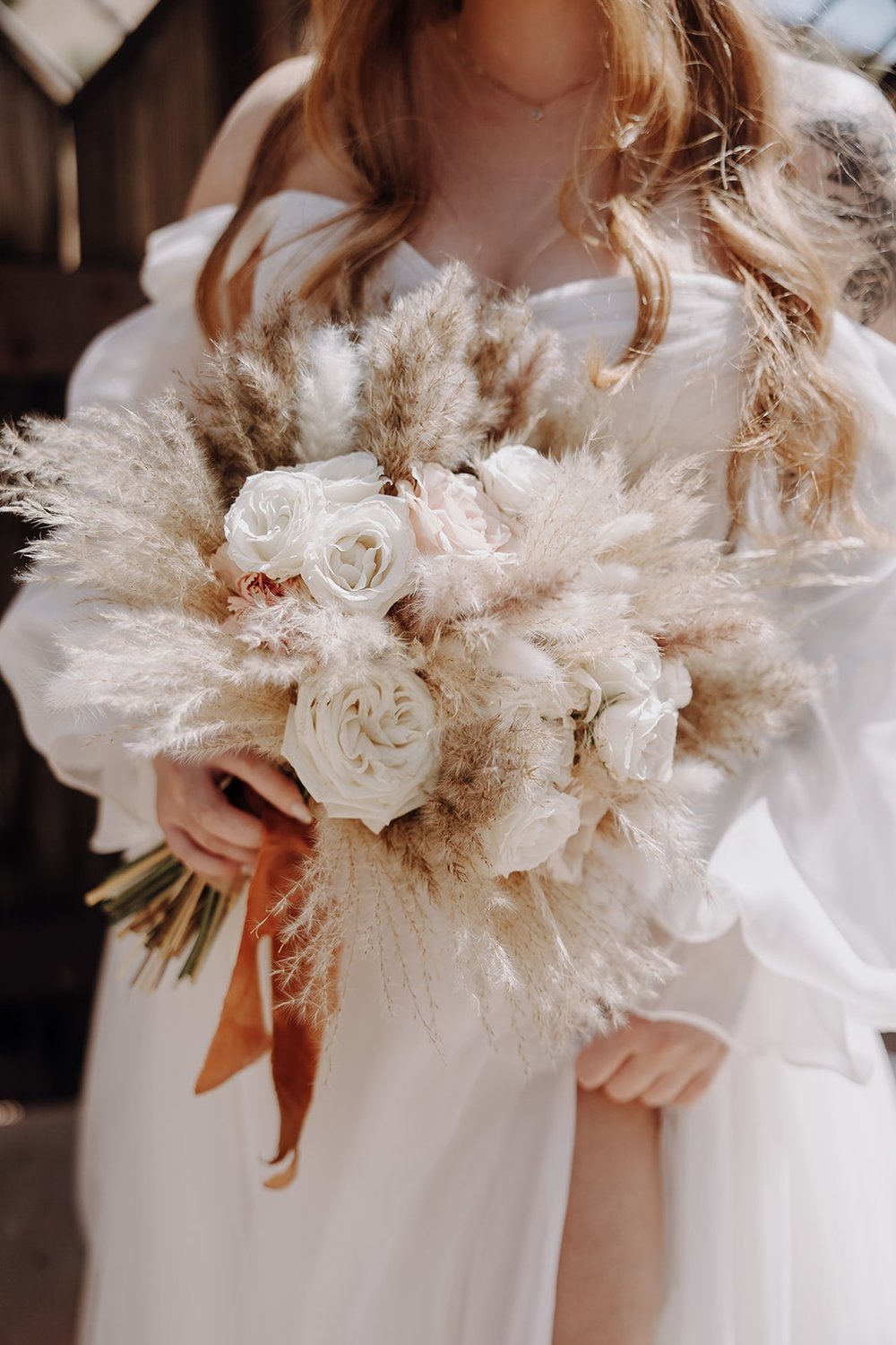 Bride holding all white flower bouquet at Joshua Tree wedding in California