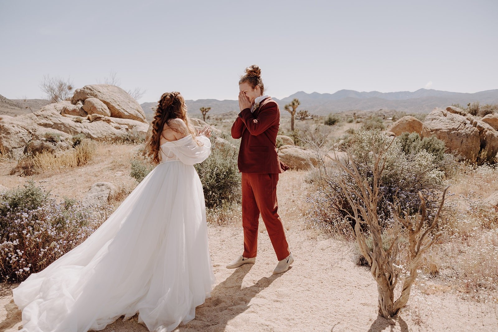 Groom reacts during wedding first look in the desert at Joshua Tree