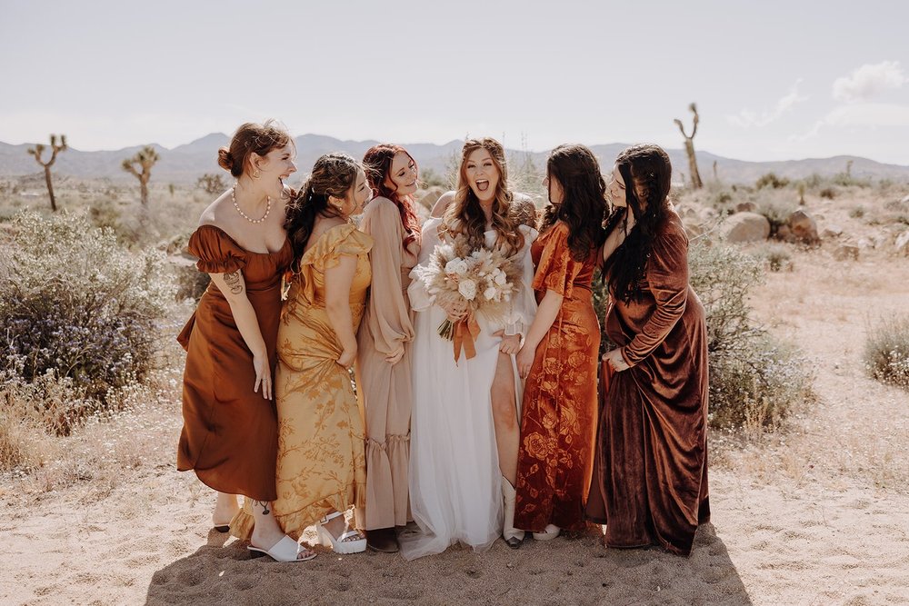 Bridal party wearing rust and yellow dresses during Joshua Tree wedding photos