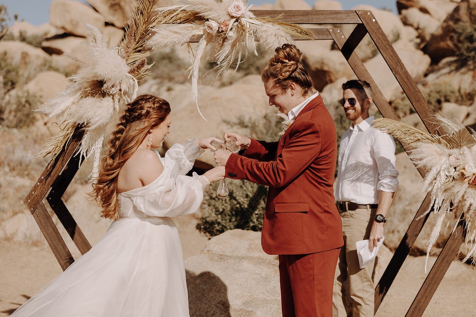 Bride and groom pour sand during wedding ceremony in Joshua Tree