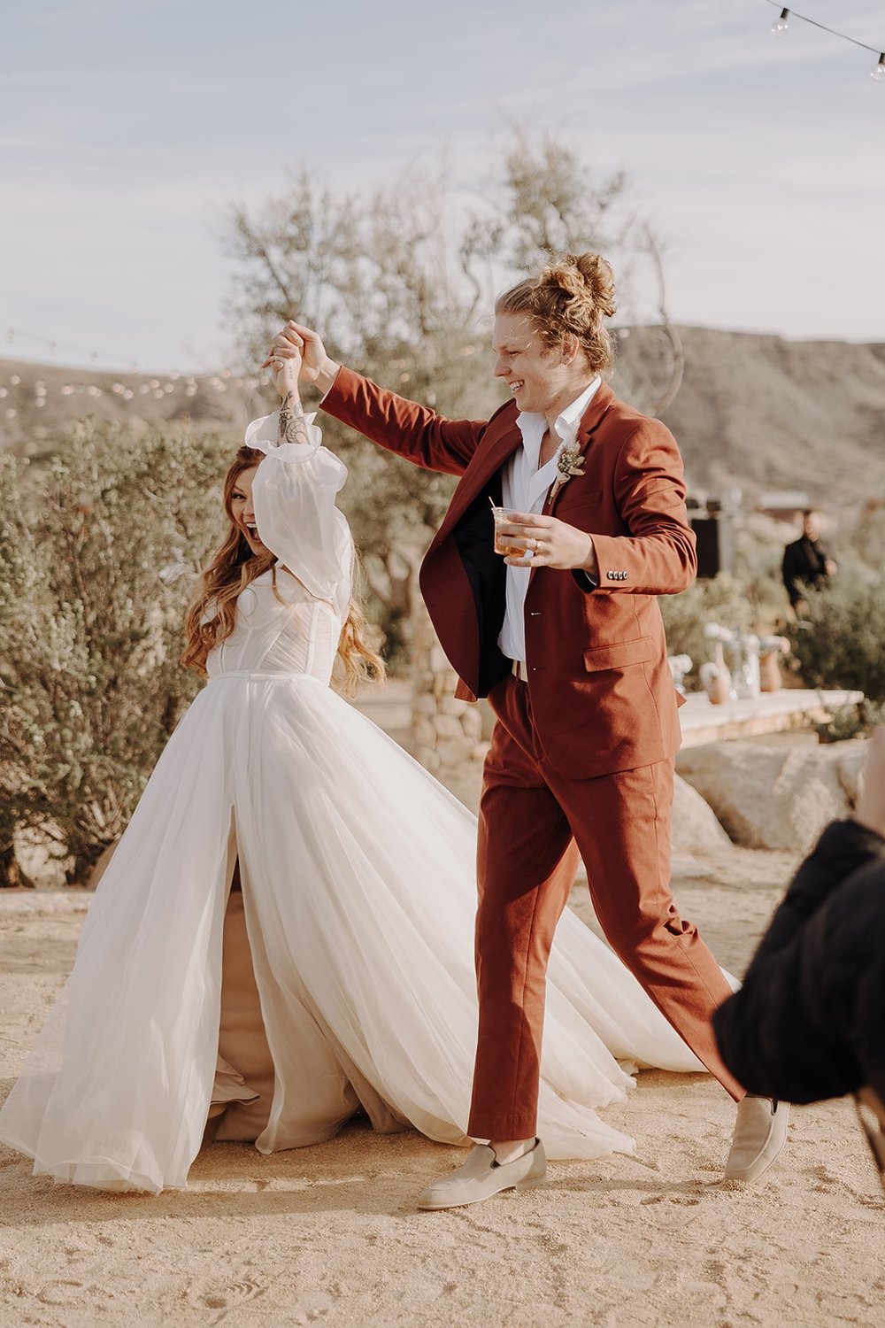 Bride and groom enter their outdoor wedding reception at The Ruin Venue