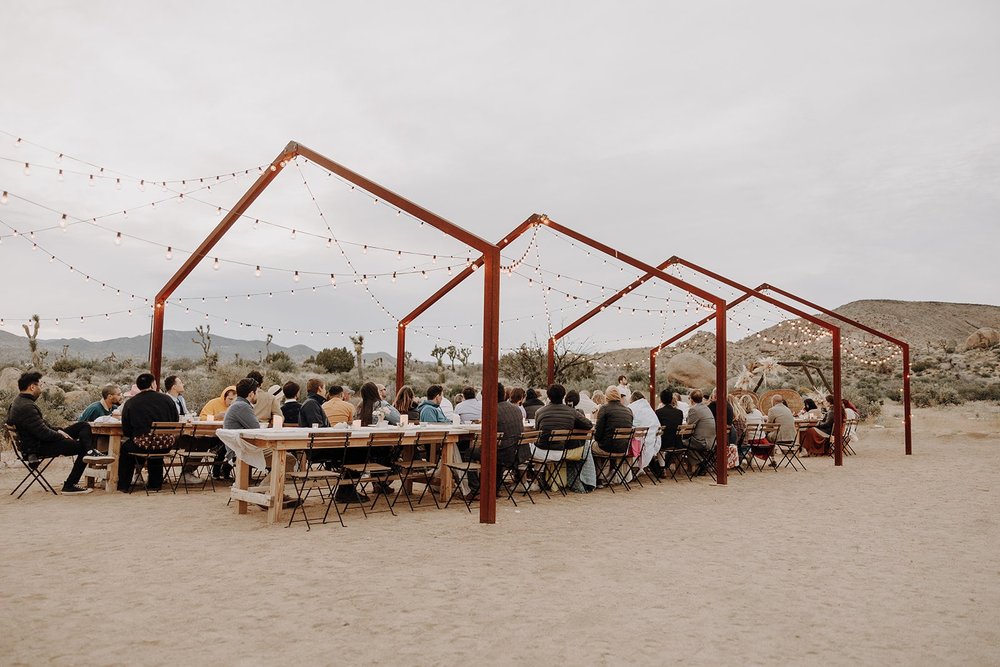 Guests sit at outdoor wedding reception at The Ruin Venue