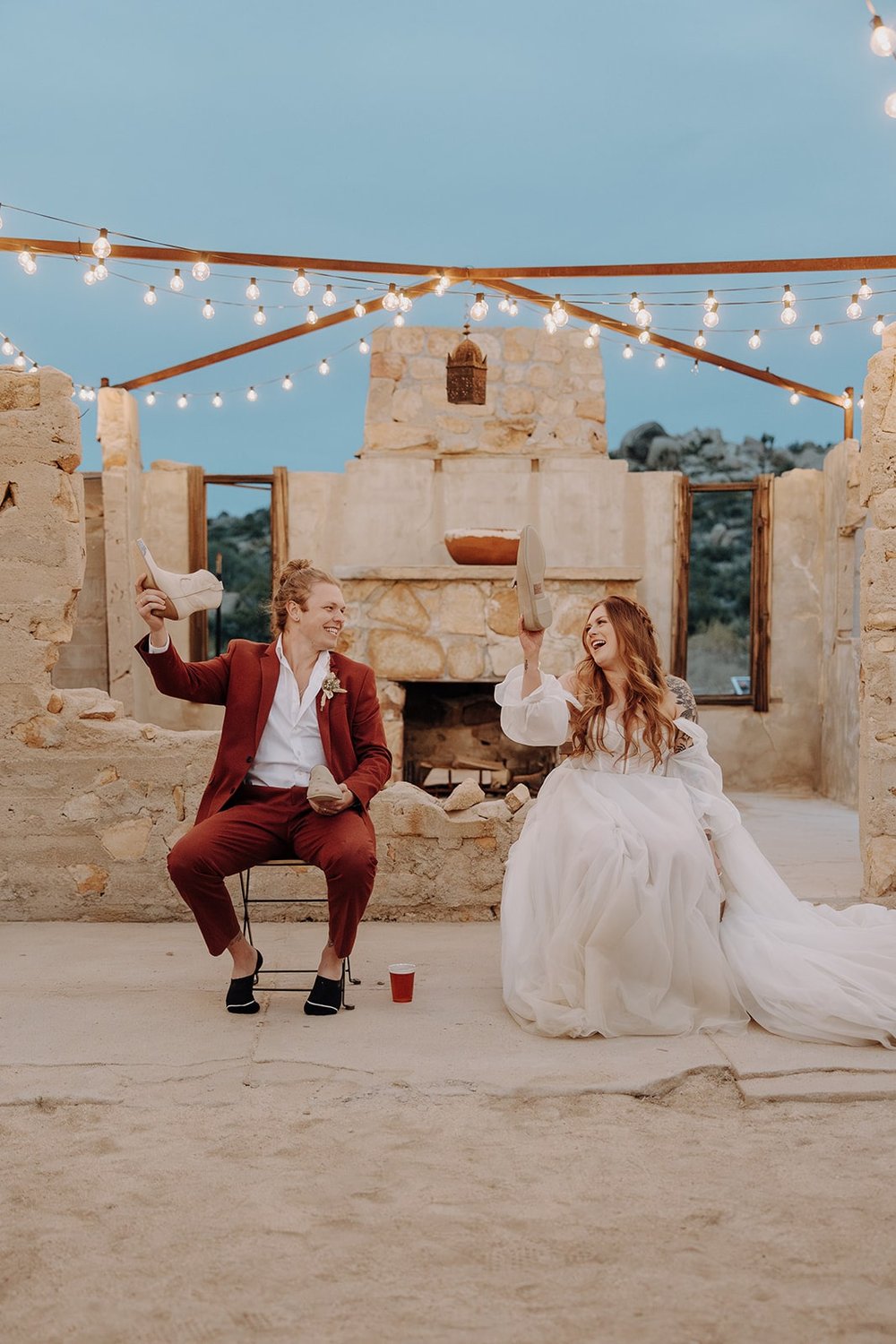 Bride and groom play the shoe game at The Ruin Venue in Joshua Tree