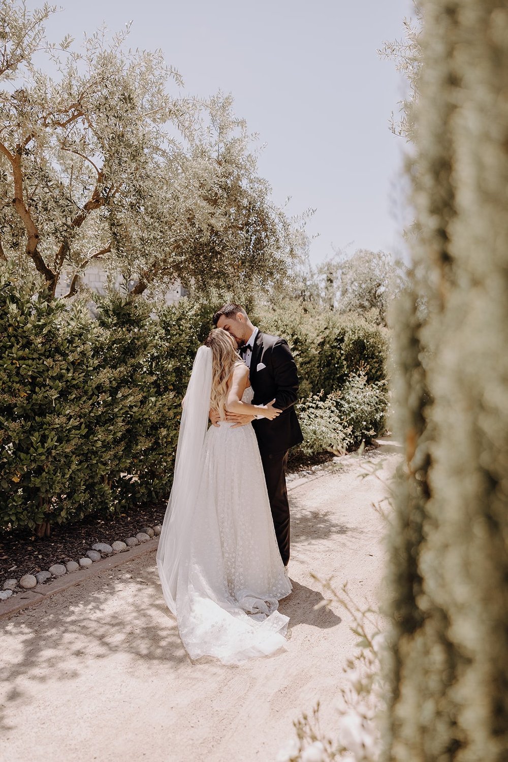 Bride and groom kiss after first look at Tuscan-style wedding in California