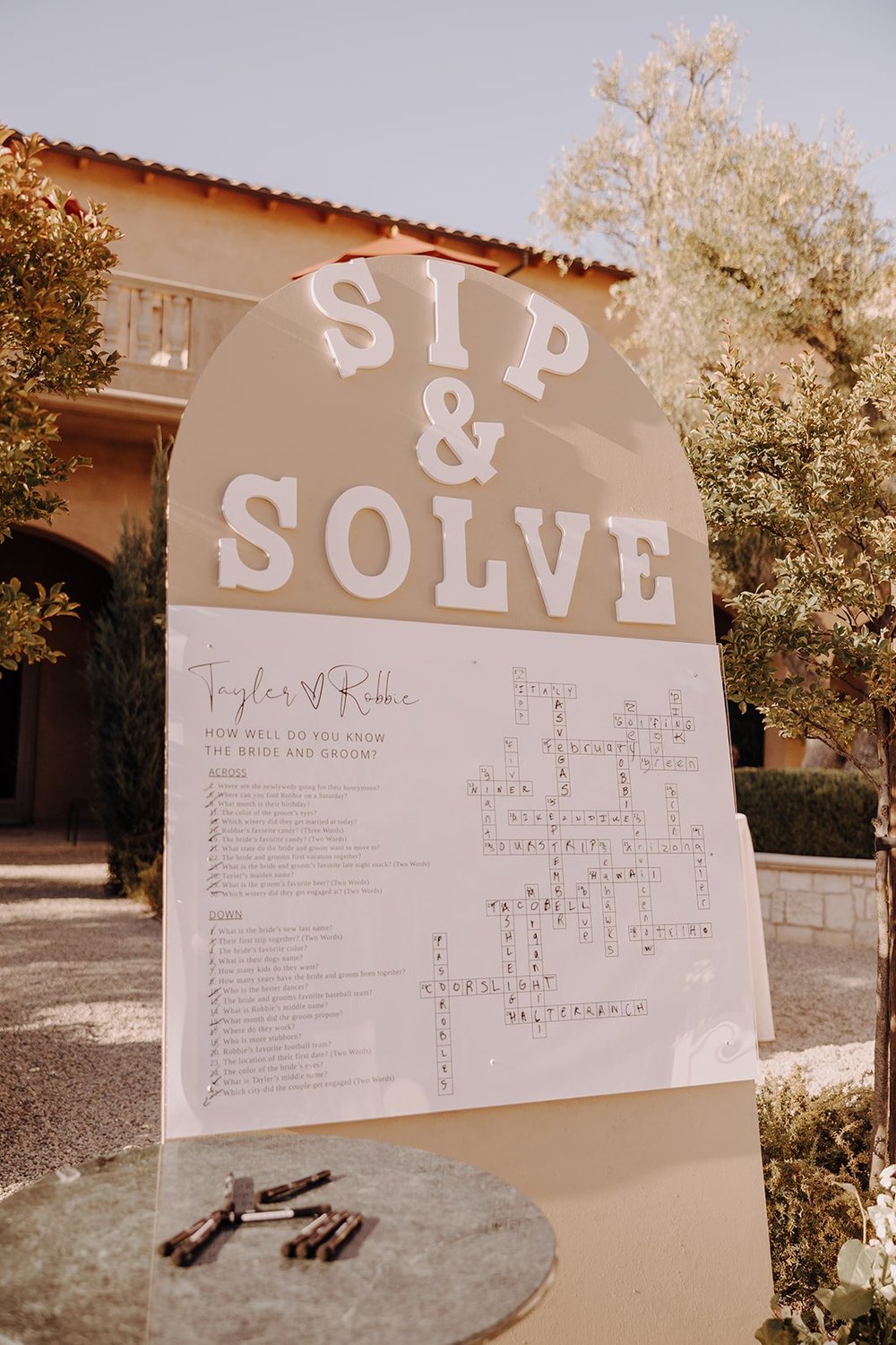 Sip and solve seating chart at Tuscan wedding reception