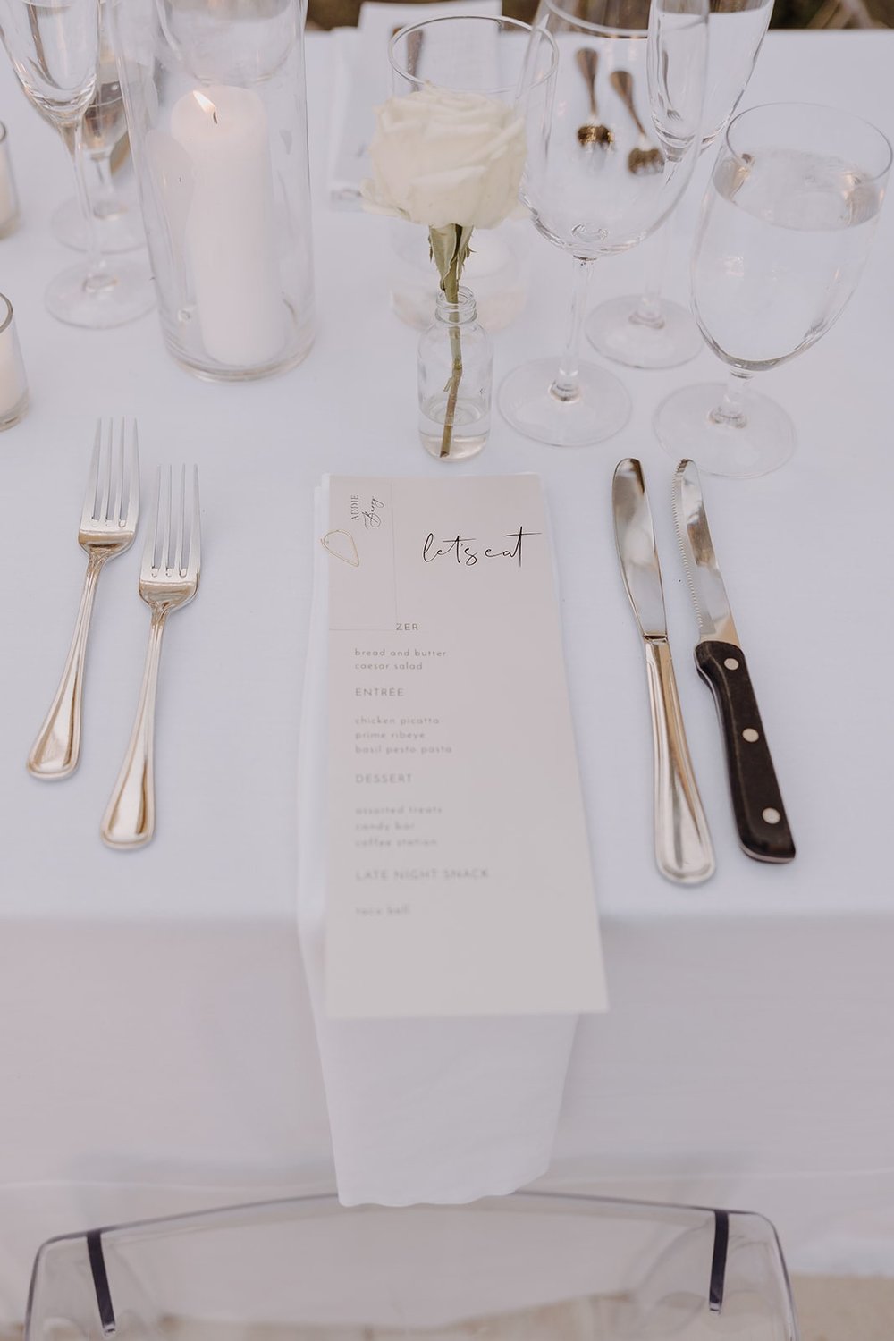 White custom wedding menu and table decor at luxury wedding in California