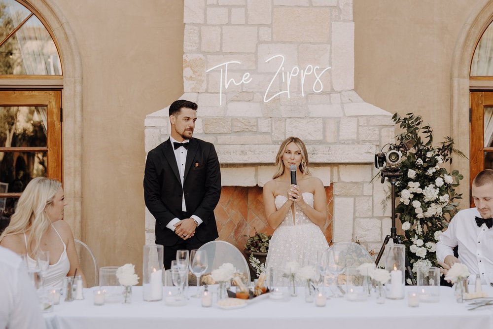 Bride gives a speech at outdoor wedding reception at Allegretto Vineyard Resort