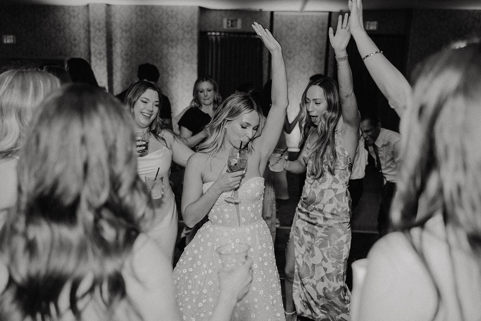 Bride dances with guests at late night wedding reception in California