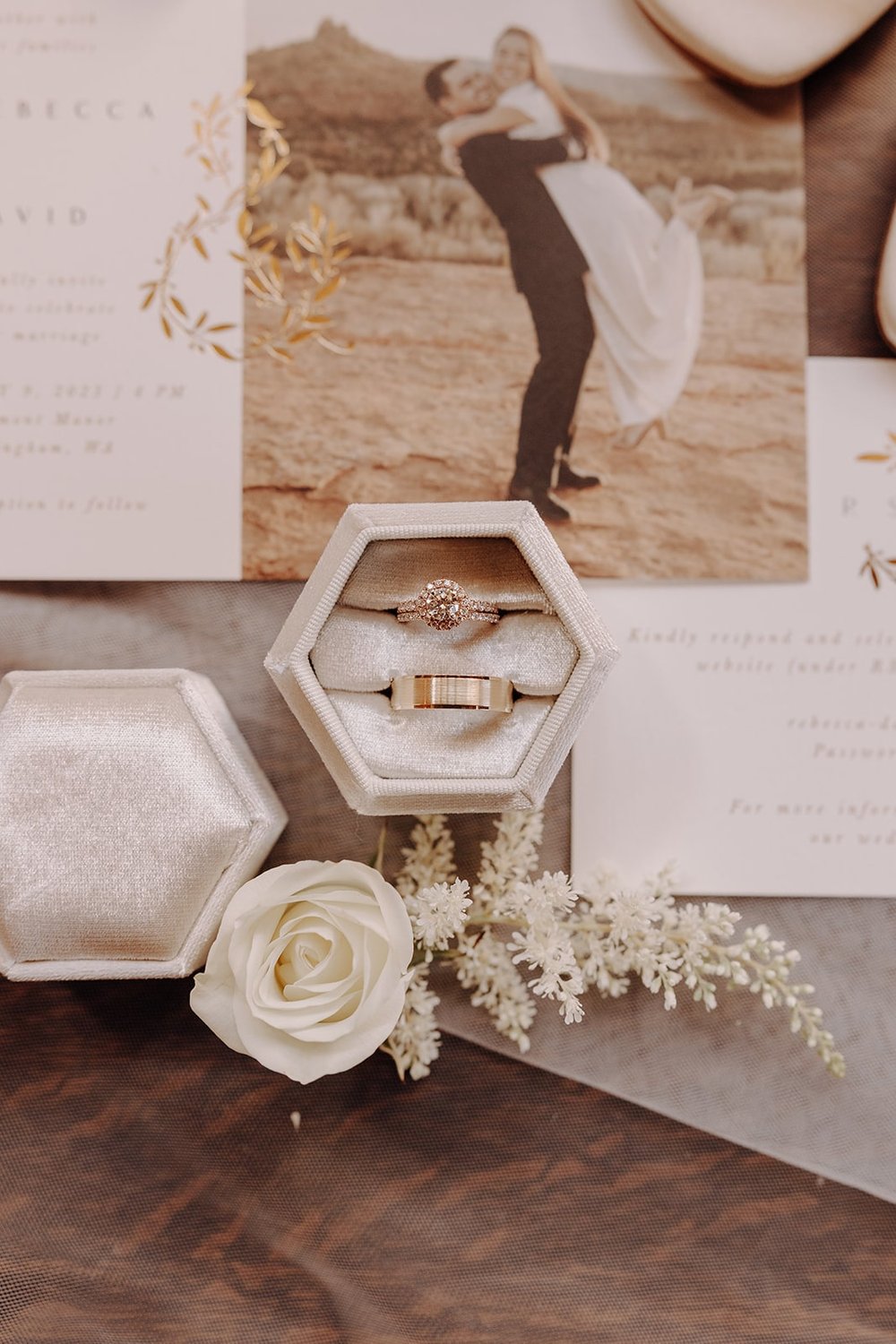 Wedding bands in white ring box with white flowers