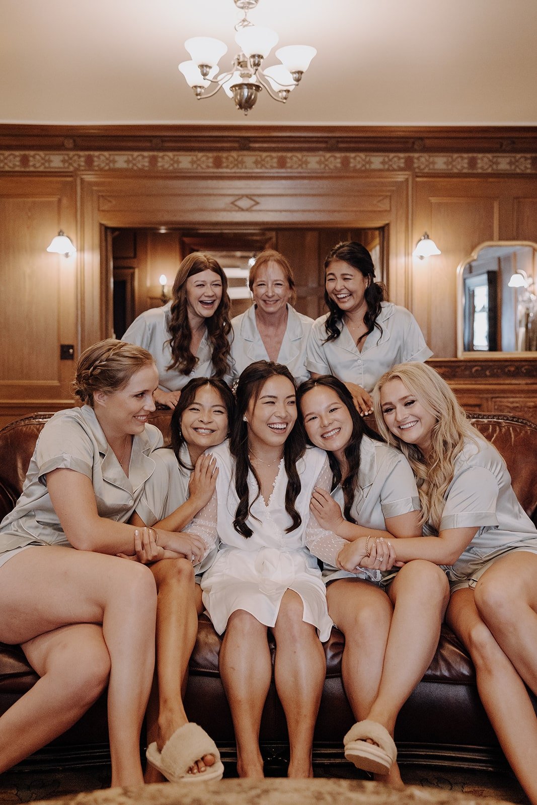 Bride and bridal party sitting in the getting ready suite at Lairmont Manor