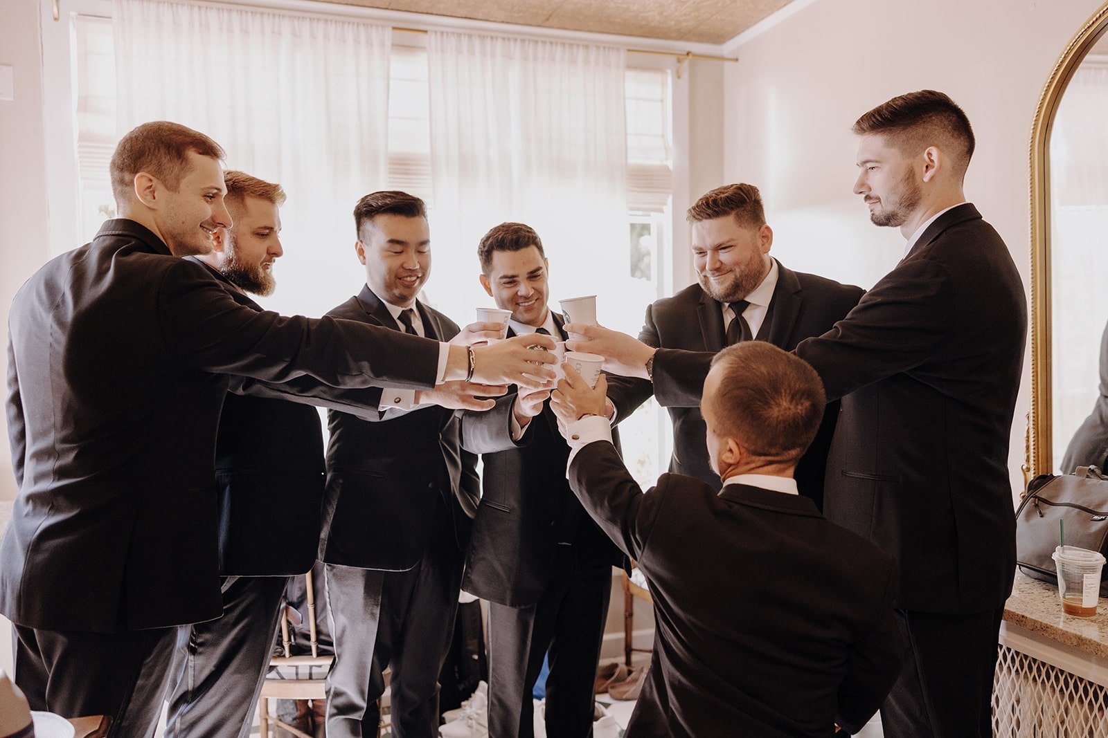 Groom and groomsmen toast after getting ready for Washington wedding at Lairmont Manor