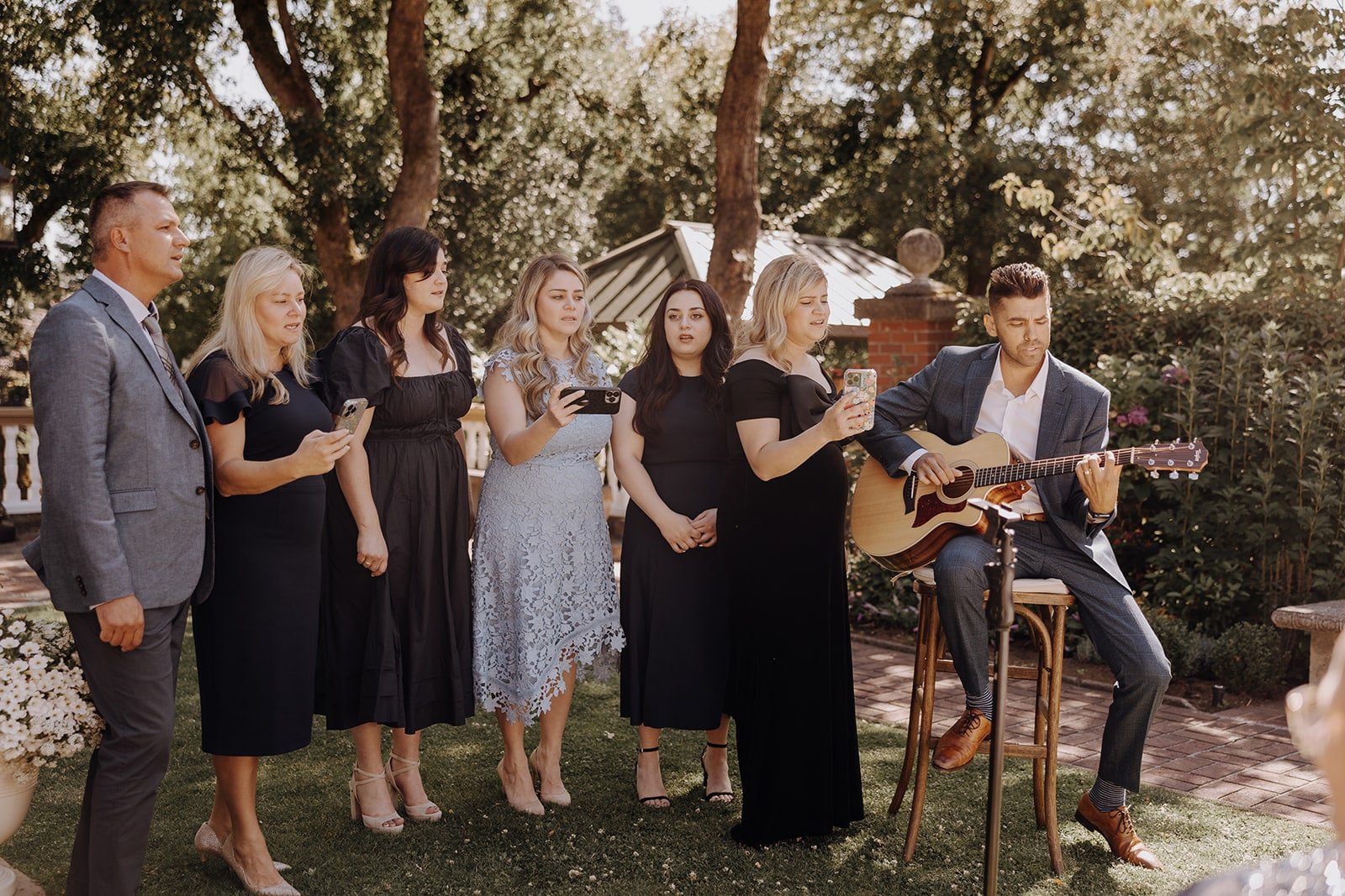 Family sings during outdoor wedding ceremony at Lairmont Manor