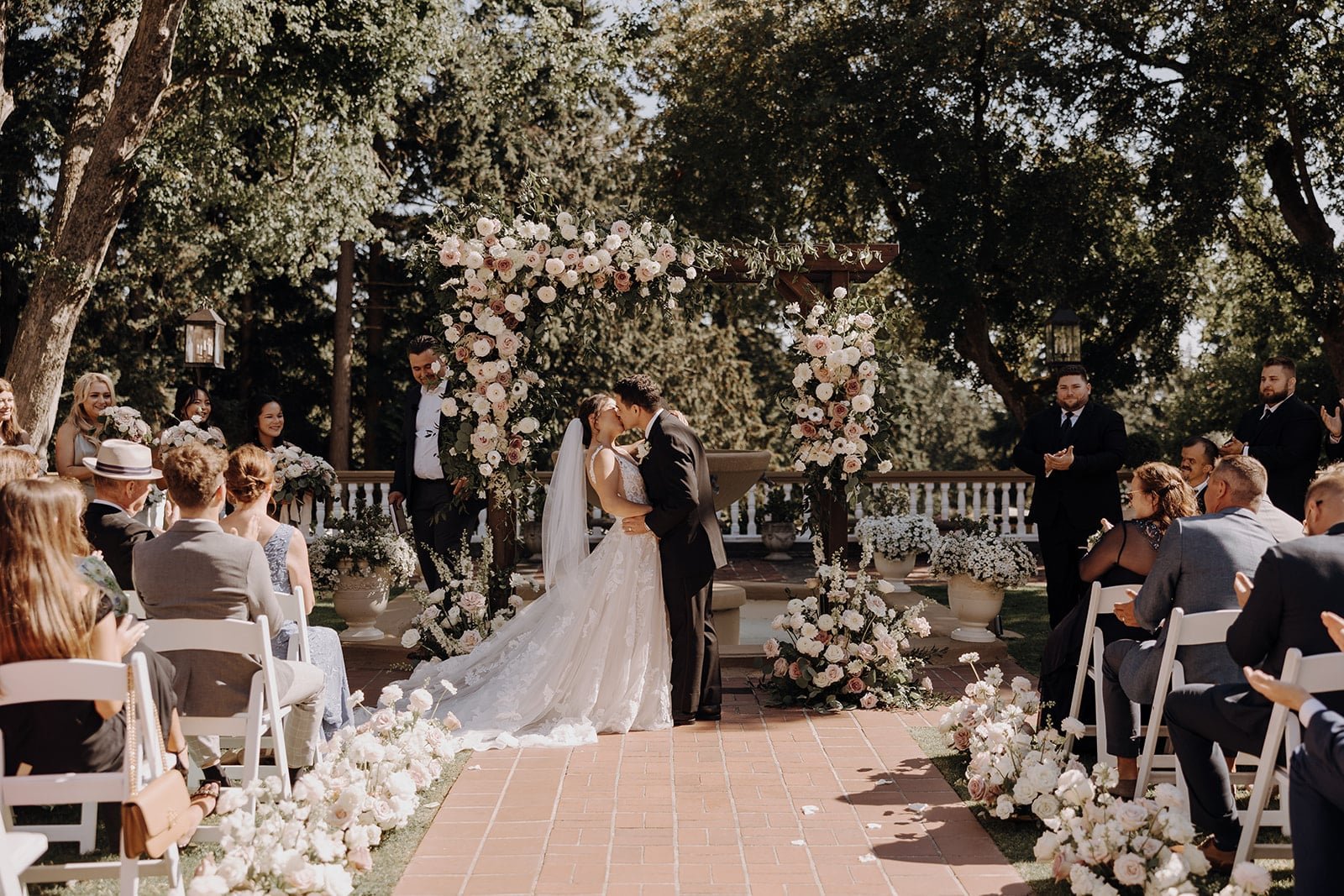 Bride and groom kiss at Washington wedding ceremony at Lairmont Manor