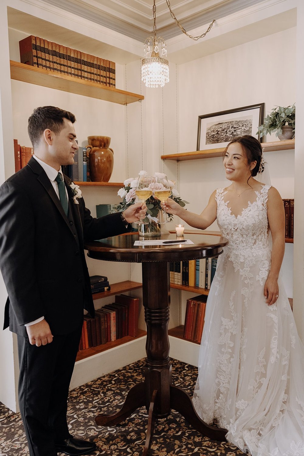 Bride and groom toast champagne before signing their marriage license at Lairmont Manor wedding