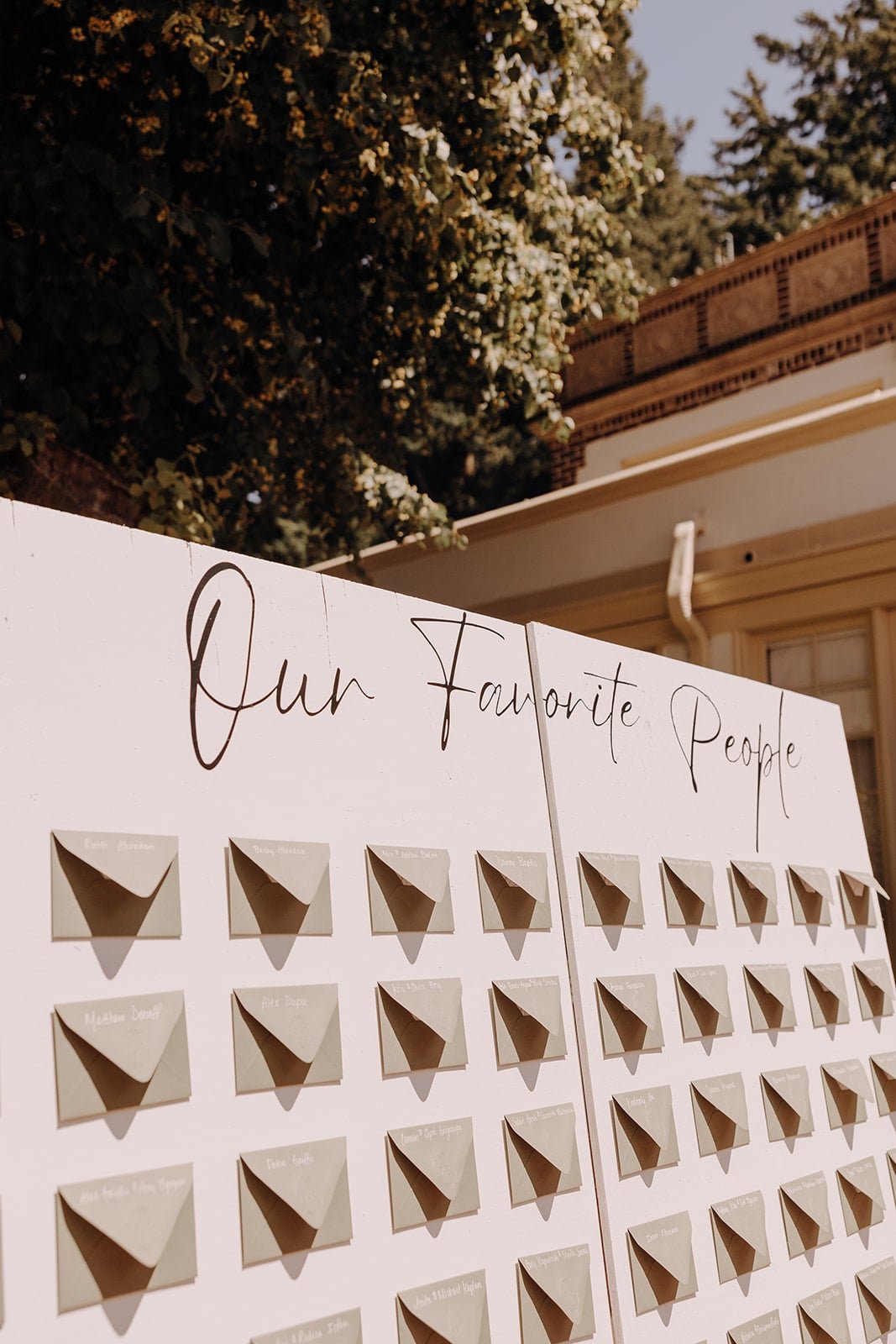 Wedding seating chart with green escort cards and envelopes