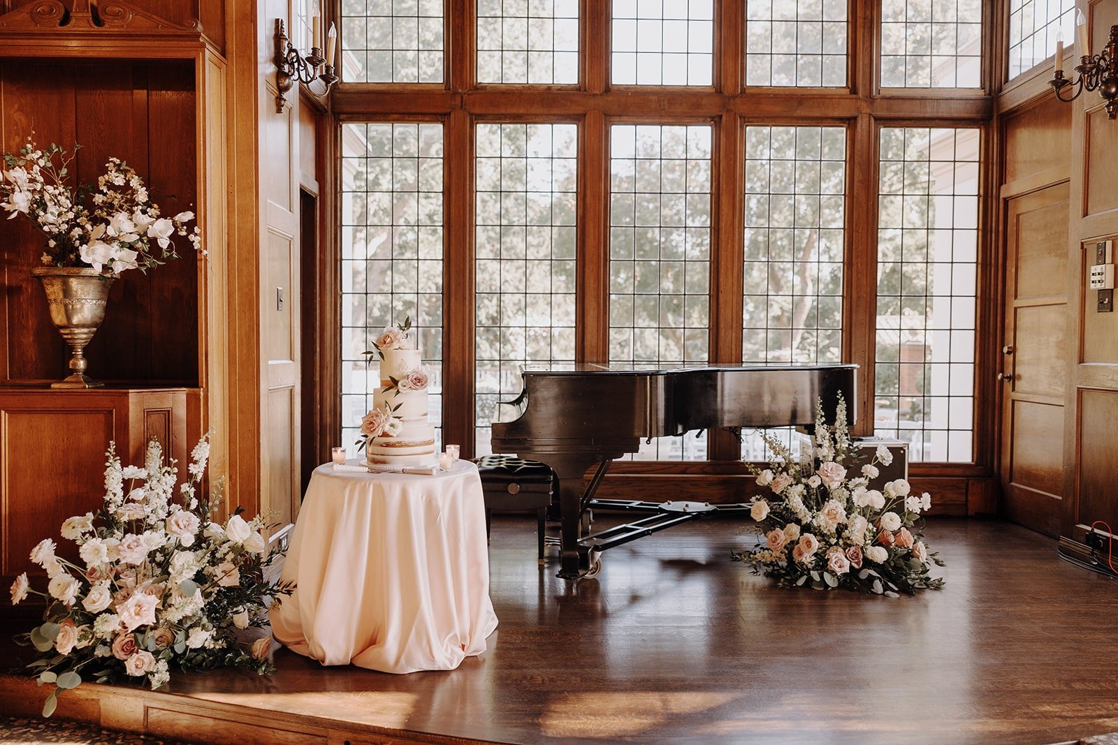 Three tier wedding cake next to black baby grand piano at Lairmont Manor wedding 