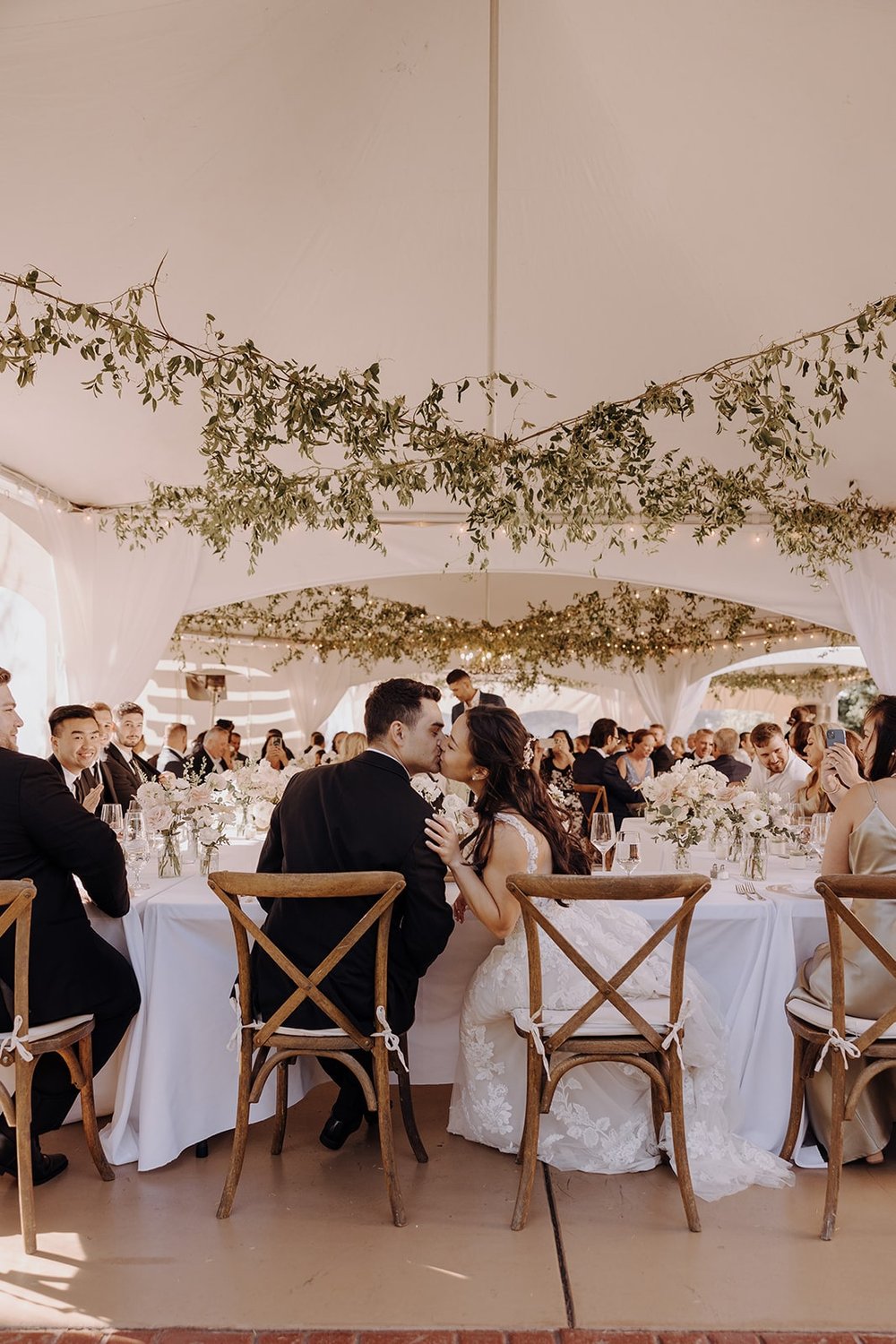 Bride and groom kiss during wedding reception at Lairmont Manor