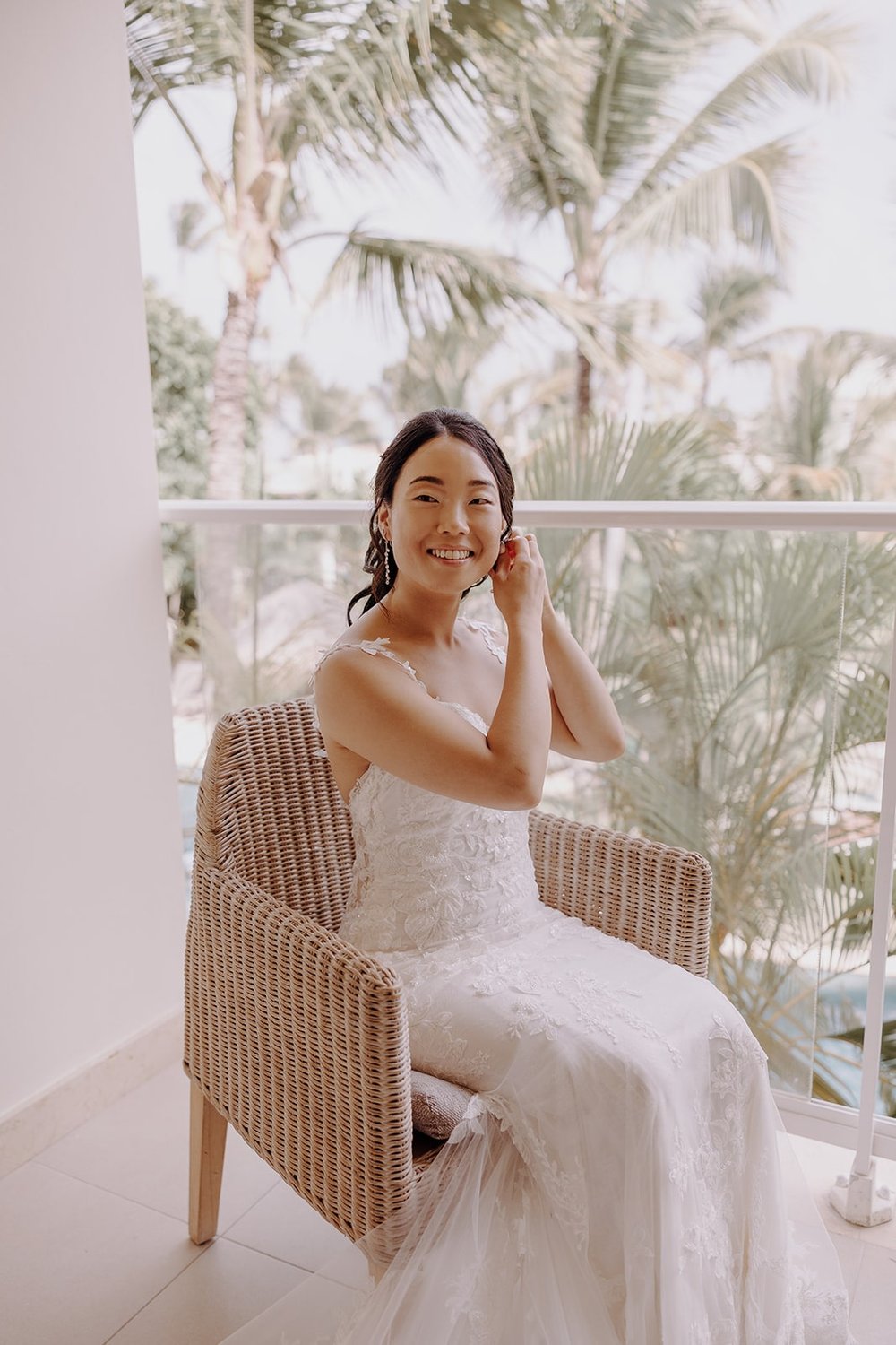 Bride adjusting earrings while getting ready for Dreams Royal Beach Punta Cana wedding