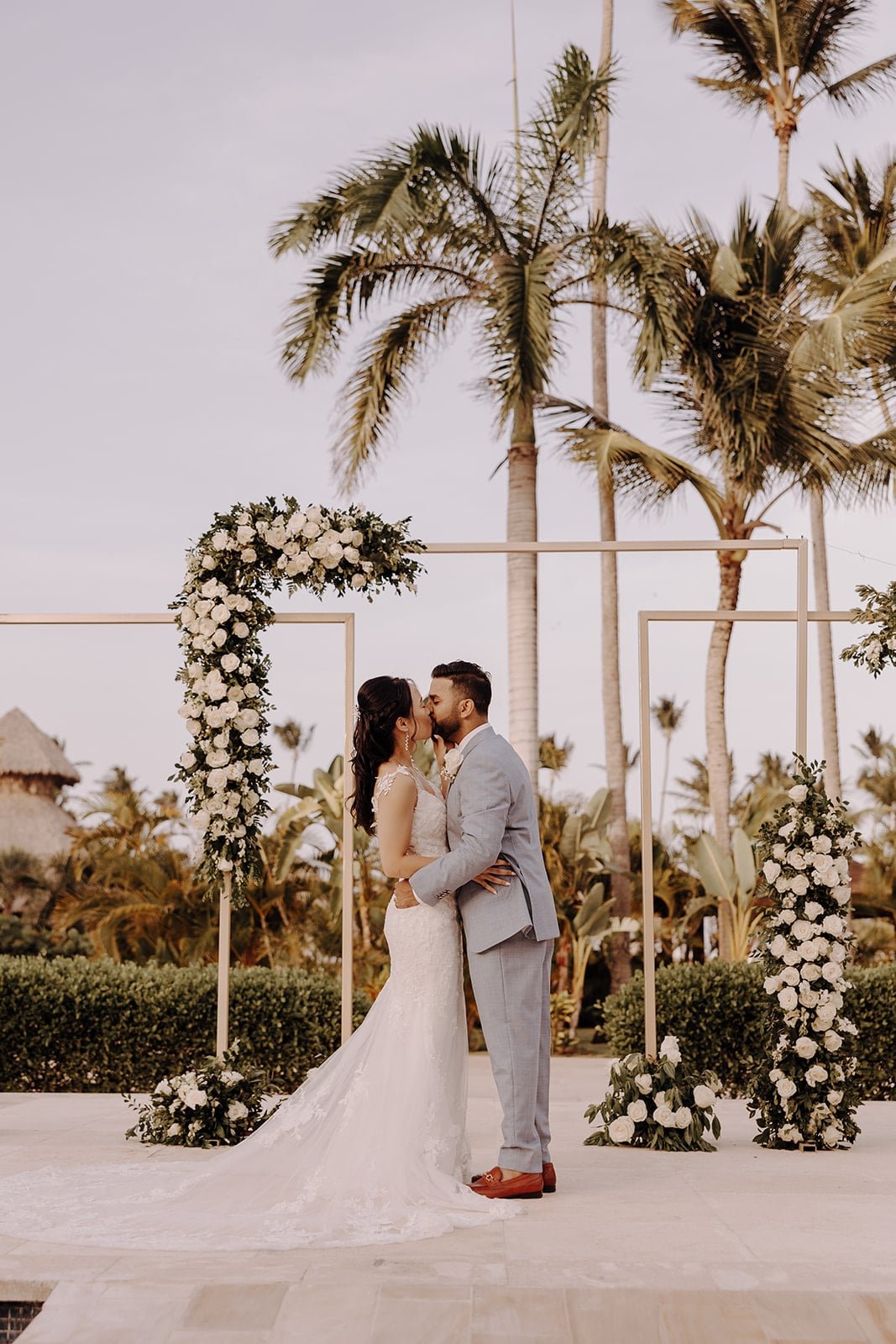 Bride and groom kiss during their Dreams Royal Beach Punta Cana wedding ceremony