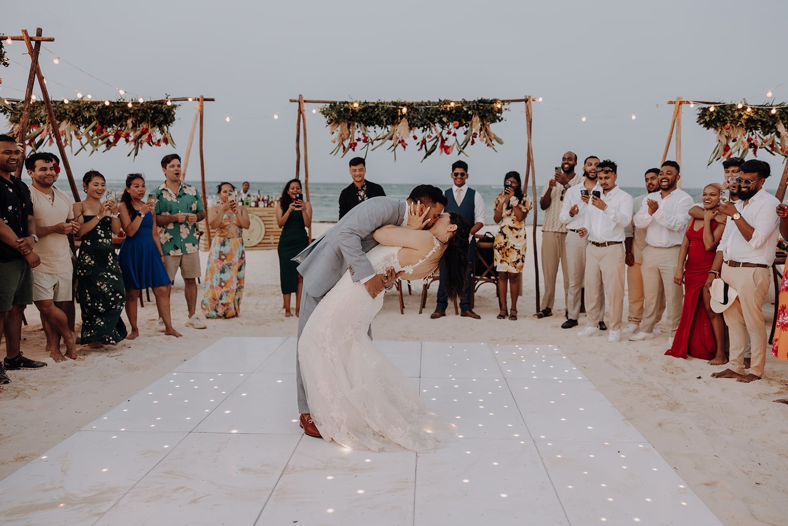 Groom dips bride for a kiss on the dance floor at their destination wedding reception in the Dominican Republic