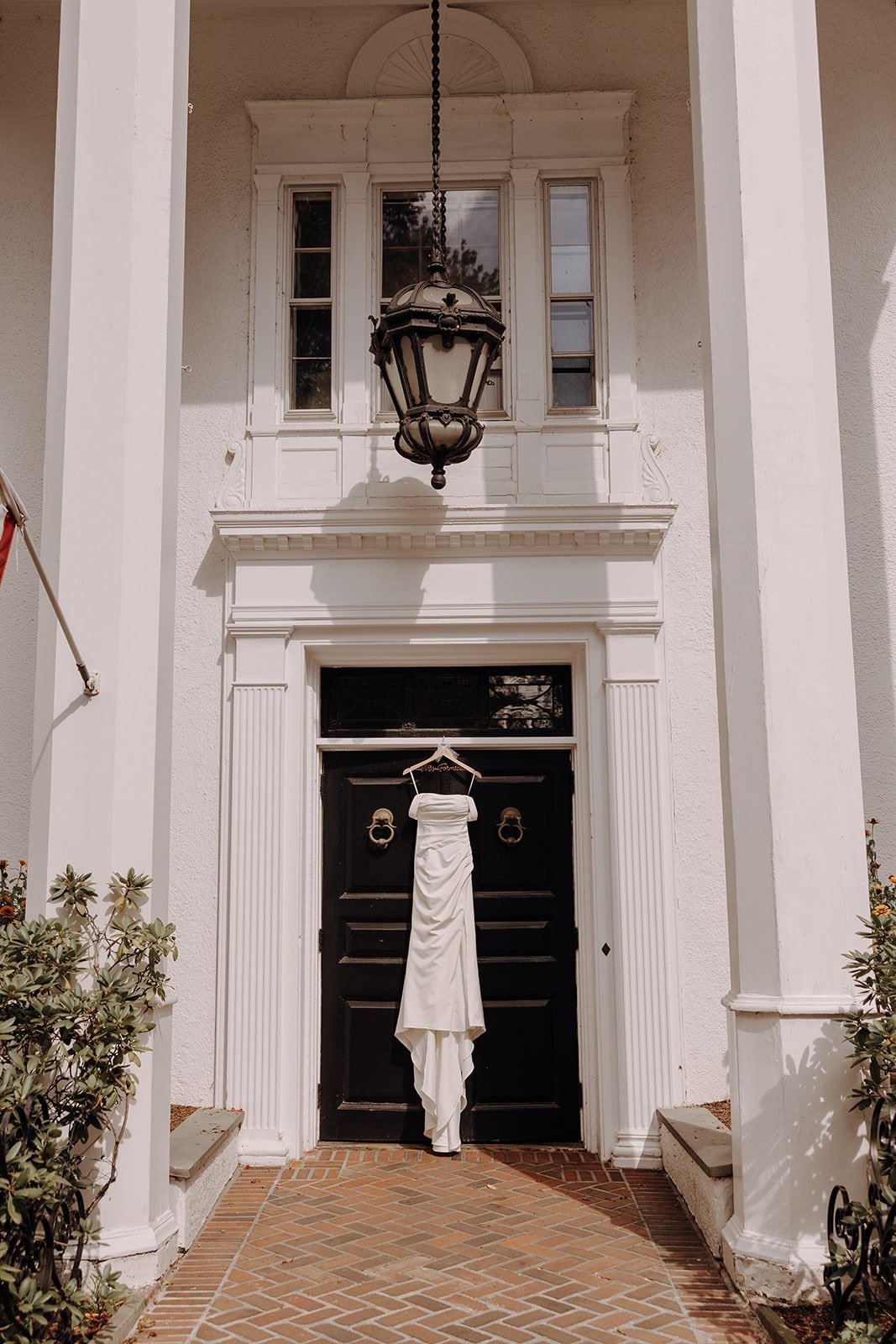 White wedding dress hanging from the door at Crabtree's Kittle House wedding venue