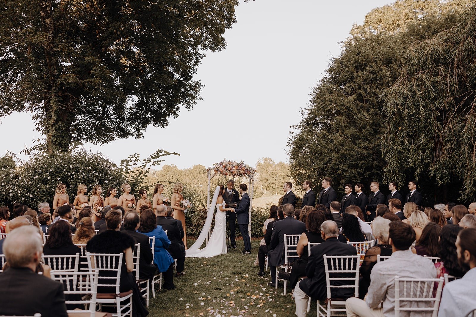 Bride and groom stand at the altar during their outdoor wedding ceremony in New York