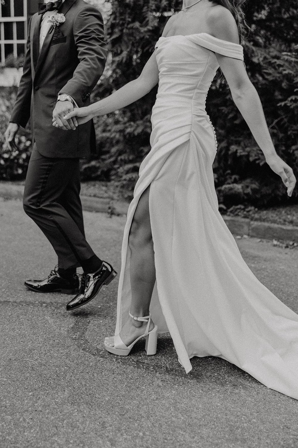 Bride and groom walk while holding hands during their wedding portraits at Crabtree's Kittle House