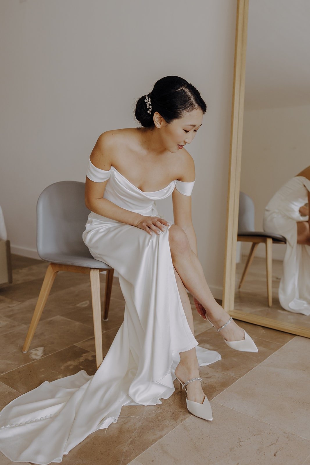 Bride slips into white pointed toe heels 