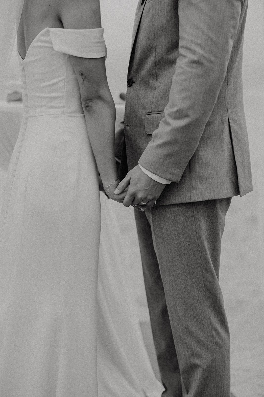 Bride and groom hold hands during their Mexico resort wedding ceremony on the beach