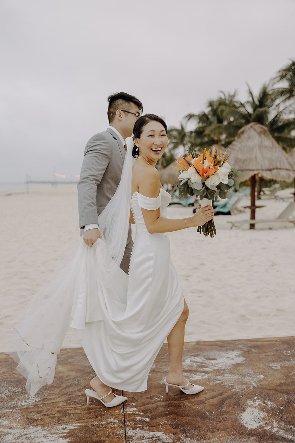 Bride and groom exit their Cancun resort wedding ceremony on the beach