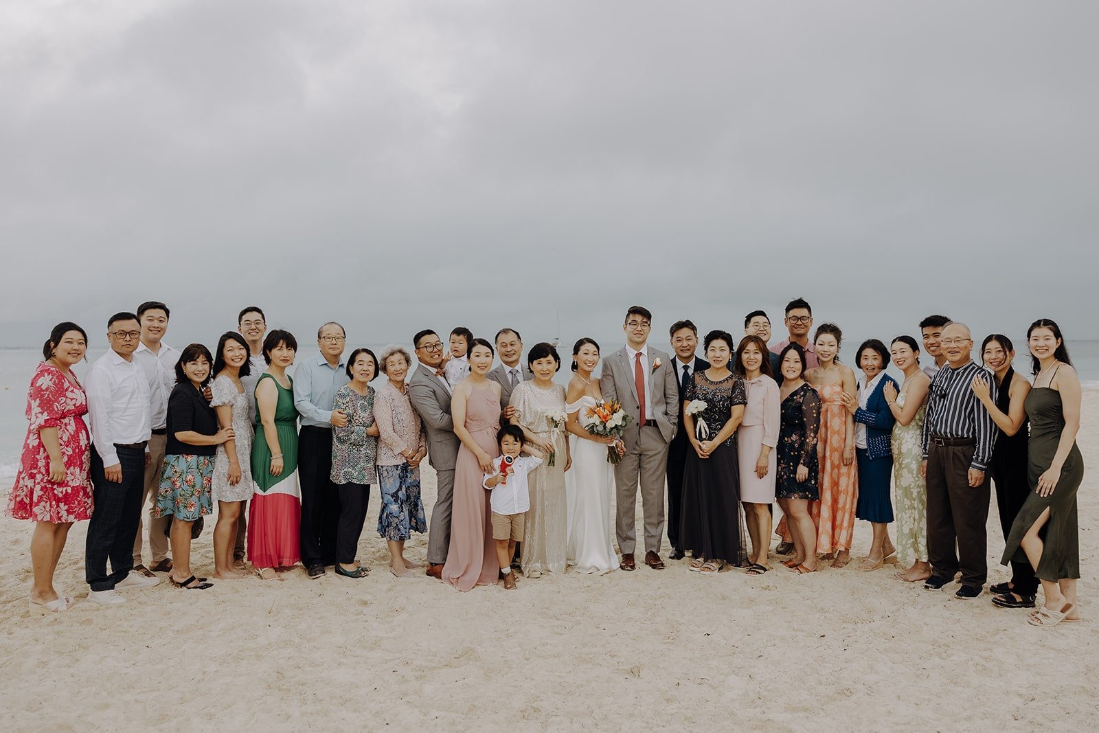Bride and groom with guests at their beach wedding in Mexico