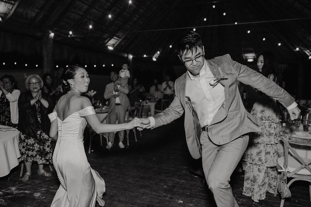 Bride and groom dance with their guests at their Mexico resort wedding in Cancun