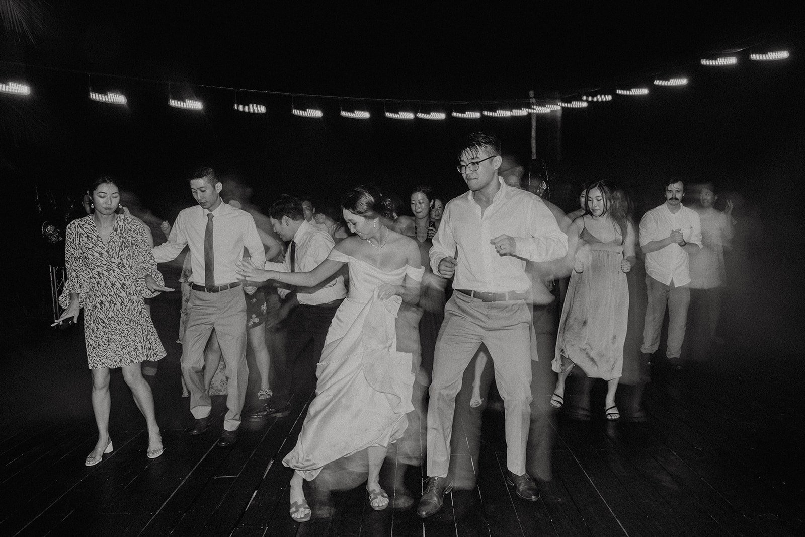 Bride and groom dance with their guests at their Mexico resort wedding in Cancun