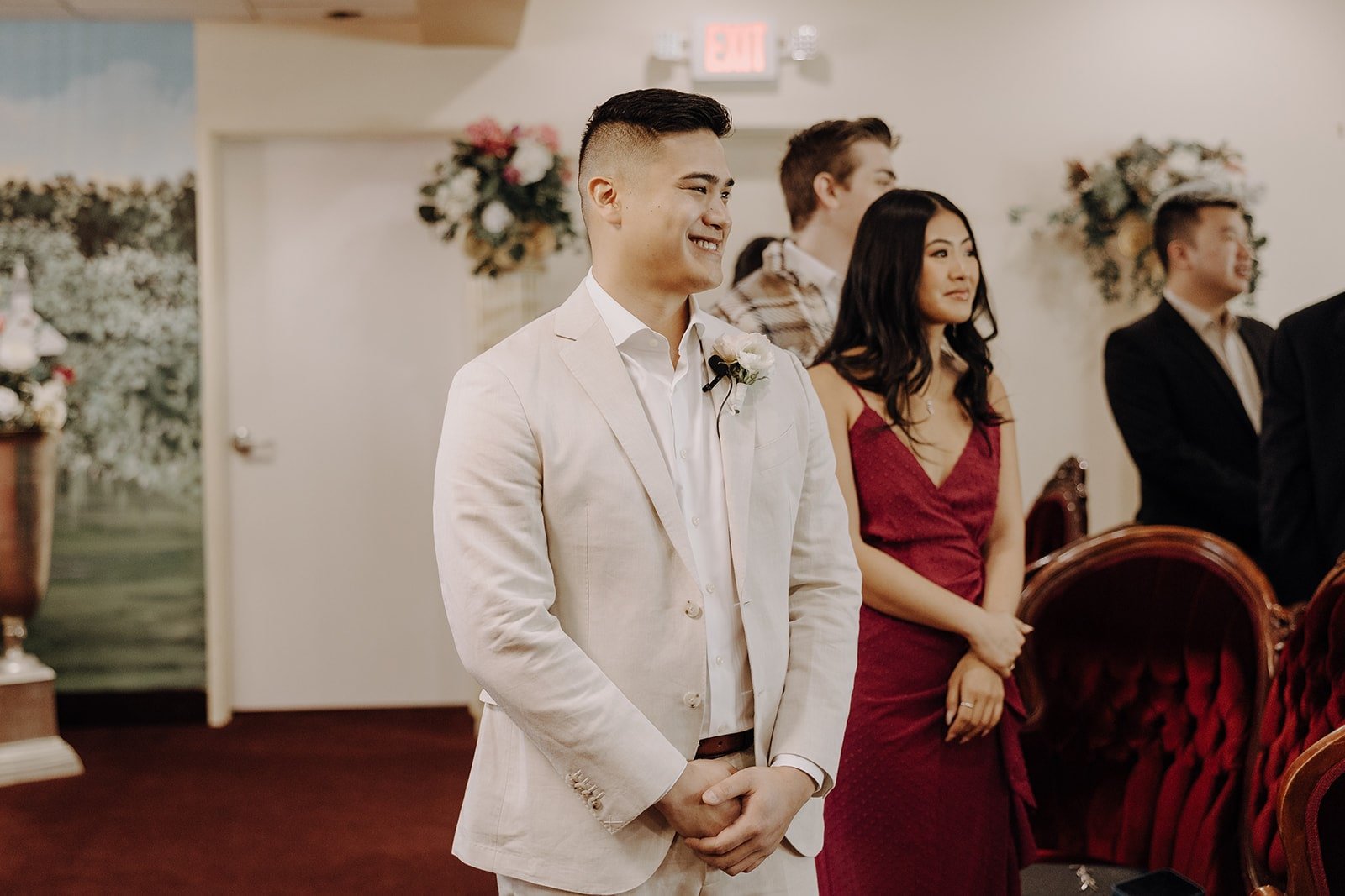 Groom smiles while standing at the altar during a Las Vegas elopement