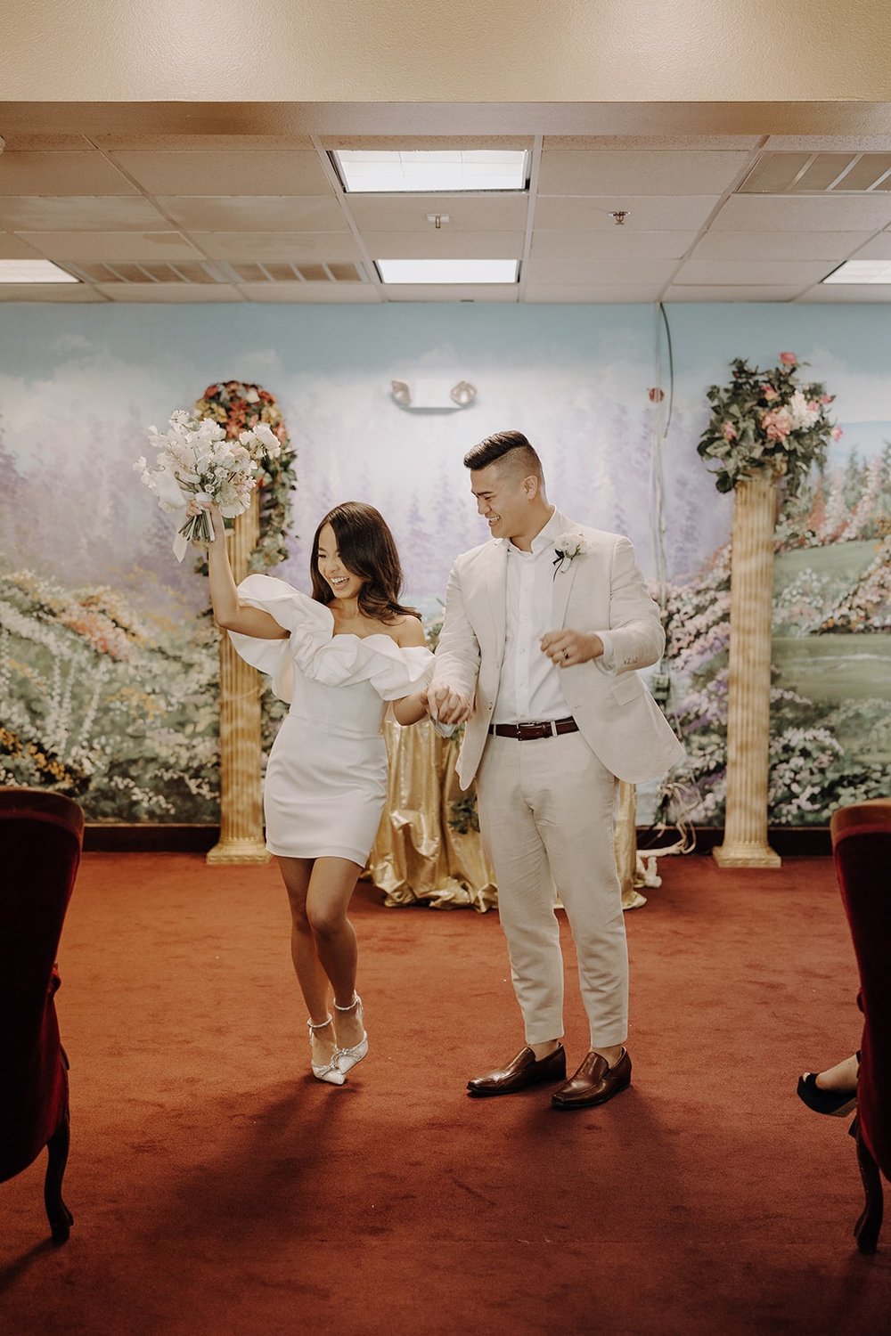 Bride and groom exit their elopement ceremony at the Little White Chapel