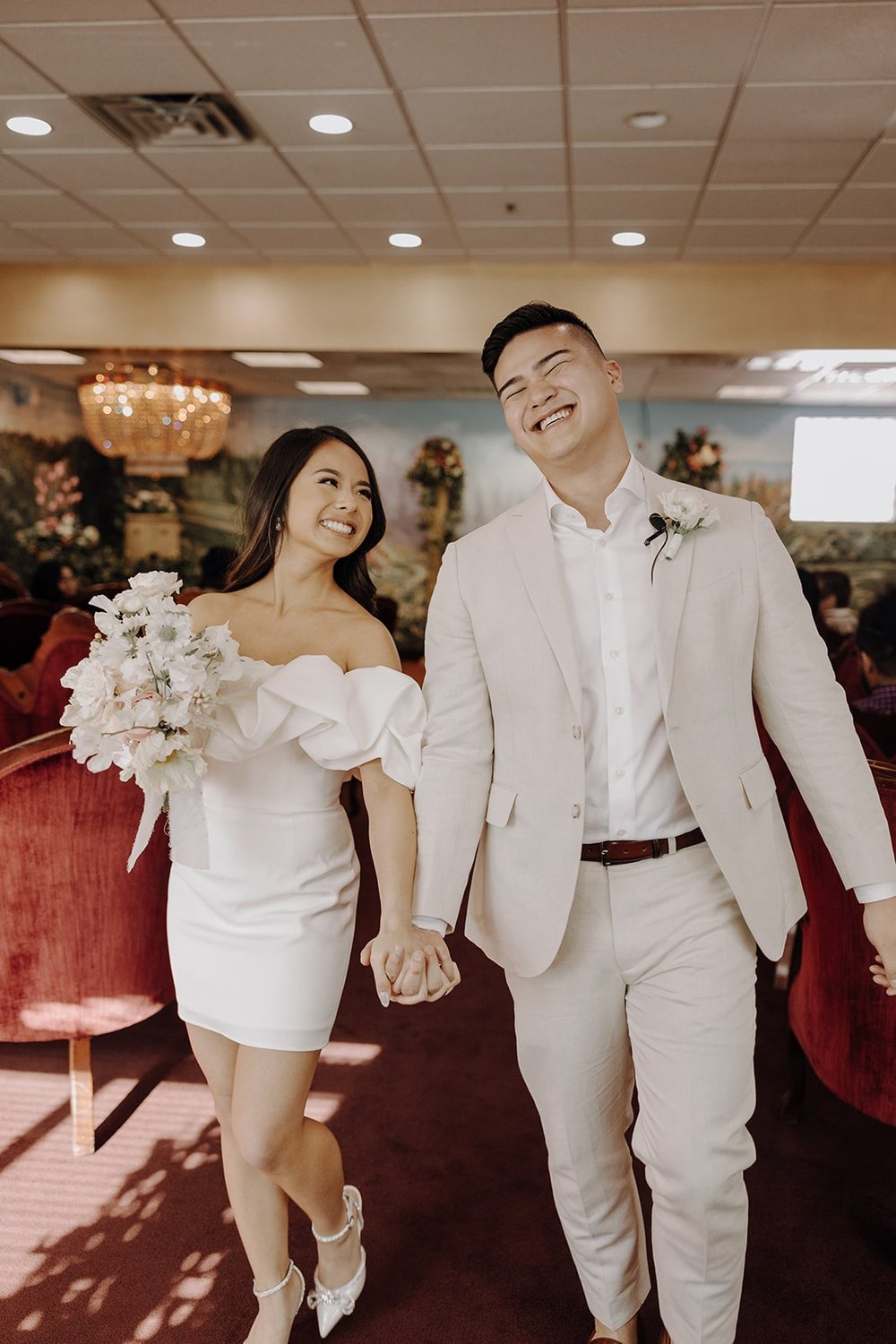 Bride and groom exit their elopement ceremony at the Little White Chapel