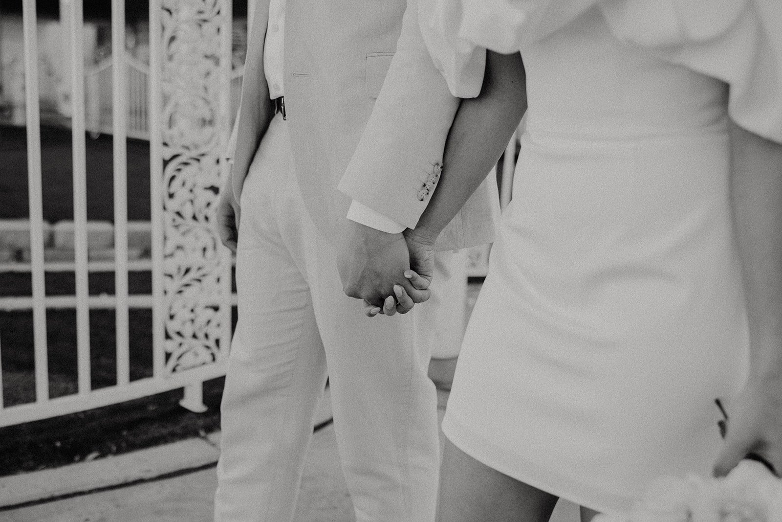Bride and groom hold hands during their Las Vegas elopement at the Little White Chapel